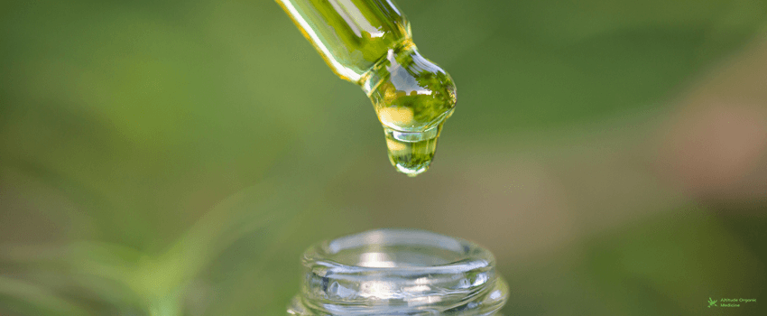 AOC-Droplet hemp oil into a glass bottle